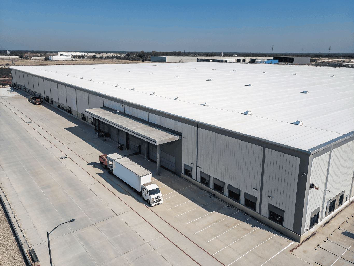 Large industrial warehouse with white TPO roofing